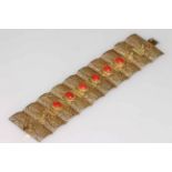Gold on silver filigree panel bracelet with cabachon coral, 8.5cm length.