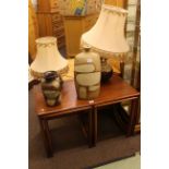 Rectangular nest of three teak tables, two pottery table lamps and shades,