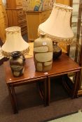 Rectangular nest of three teak tables, two pottery table lamps and shades,