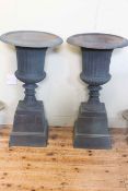 Pair cast Campana style garden urns on stepped bases, 87cm by 47cm diameter.
