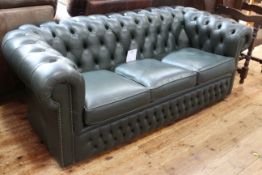 Green deep buttoned leather three seater Chesterfield settee.