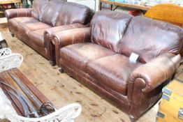 Pair brown distressed leather three seater and two seater settees.