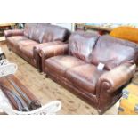 Pair brown distressed leather three seater and two seater settees.