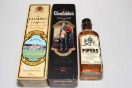 Three bottles of whisky, Glenlivet 12 years, Glenfiddich malt, and Hundred Pipers.