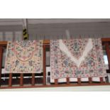Two similar floral needlework rugs (largest 1.50 by 0.88).
