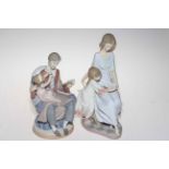 Two Lladro groups of mother and father reading to a child, tallest 27cm.