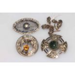 Collection of four Scottish and other silver brooches.