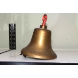 Brass bell, 29cm high.