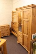 Three piece pine bedroom suite comprising combination wardrobe,