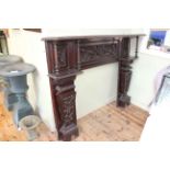 Late 19th/early 20th Century carved oak fire surround, 129cm by 165cm by 30cm.