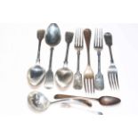 Silver flatware including fiddle pattern dessert spoons and forks and sauce ladle.