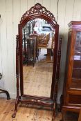 Polished mahogany arched top bevelled cheval mirror on ball and claw legs, 200cm.