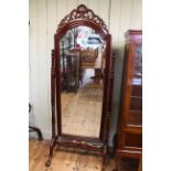 Polished mahogany arched top bevelled cheval mirror on ball and claw legs, 200cm.