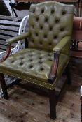 Green buttoned leather library chair.