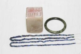 Green jade Chinese bangle, large soapstone seal and two Lapis Lazuli bead necklaces.