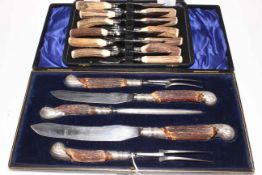 Cased set of horn handled carvers and a cased set of horn handled fish eaters.