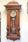 Victorian walnut cased Vienna wall clock having brass and copper dial (lacking weights).