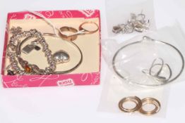 Small collection of gold and silver jewellery including charm bracelet and rings.