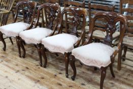Set of four Victorian mahogany dining chairs with serpentine front seats.