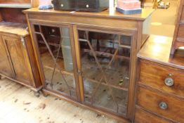 Edwardian mahogany and line inlaid astragal glazed two door bookcase on bracket feet,