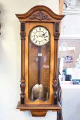 Victorian walnut cased double weight Vienna wall clock having enamelled dial.