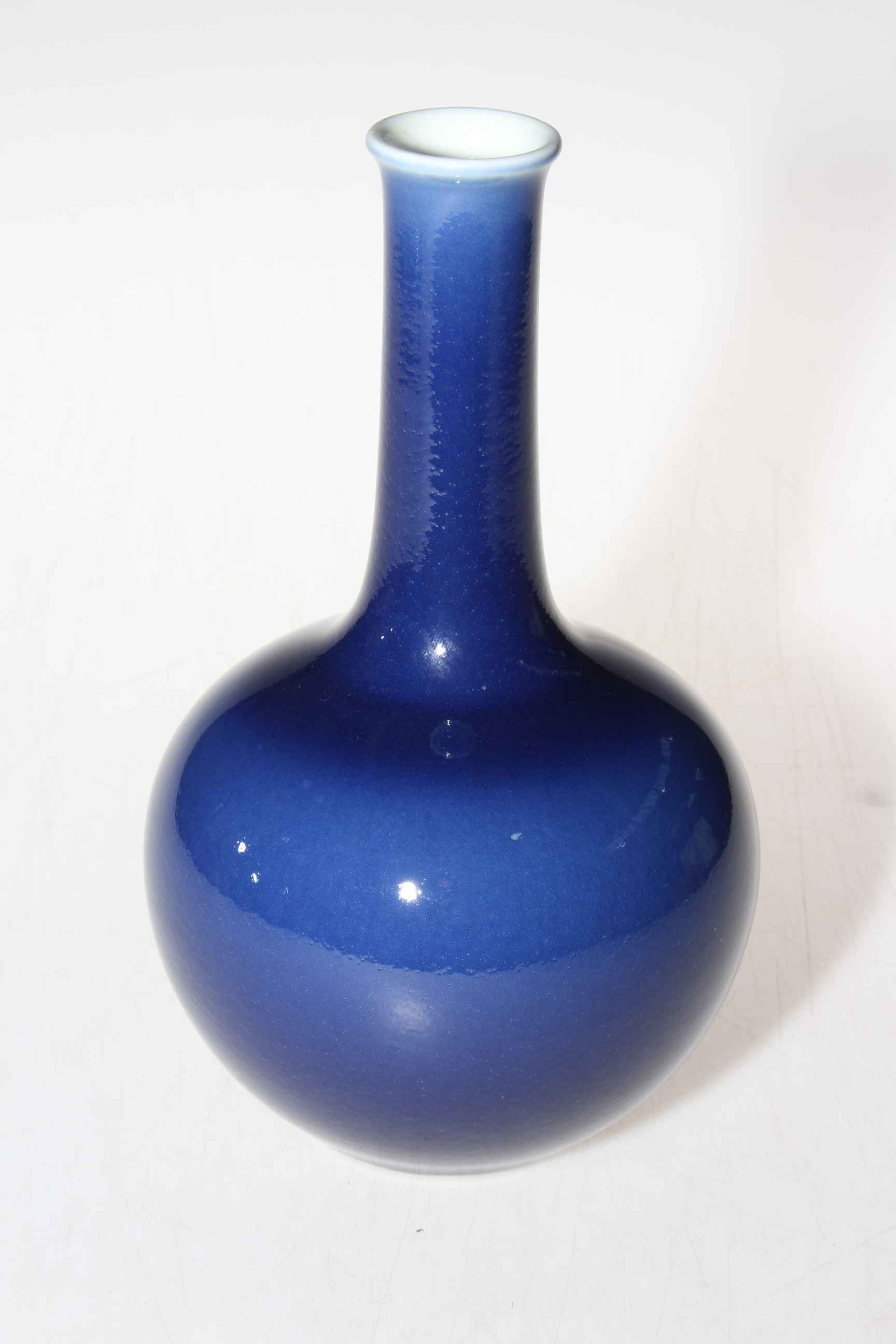 Chinese blue glazed bottle neck vase with Qianlong mark to base, 21cm high.