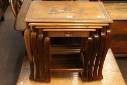 Nest of four carved hardwood occasional tables (largest 49cm by 53cm by 32cm).