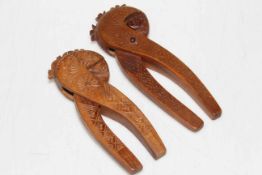 Two sets of carved wood nut crackers.