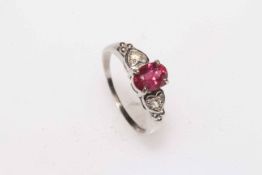 Oval ruby and white stone ladies dress ring set in 9 carat white gold, size P.