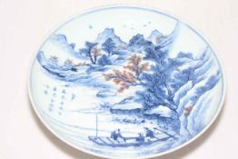 Chinese circular blue and white plate decorated with figures in boat in lake and mountainous scene,