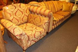 Three seater settee and chair in striped and foliate pattern fabric.