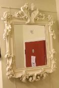 Ornate French style framed bevelled wall mirror.