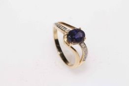 9 carat gold, oval iolite and diamond crossover ring, size N.