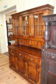 Oak dresser having three glazed panel cupboard doors above a base of three drawers with three