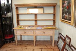 Two drawer pine dresser and associated Delft rack, 181cm by 180cm by 67cm.