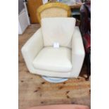 Cream leather swivel armchair.