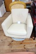 Cream leather swivel armchair.