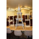 Three tier graduated rack and pair wrought metal three tier plant stands (3).