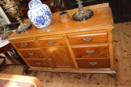 Victorian pine dresser having central drawer above a cupboard door flanked by six drawers on six