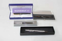 Four biro pens including Waterman and silver strap.