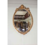 Antique oval gilt framed wall mirror, 55cm by 38cm including frame.