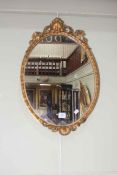 Antique oval gilt framed wall mirror, 55cm by 38cm including frame.