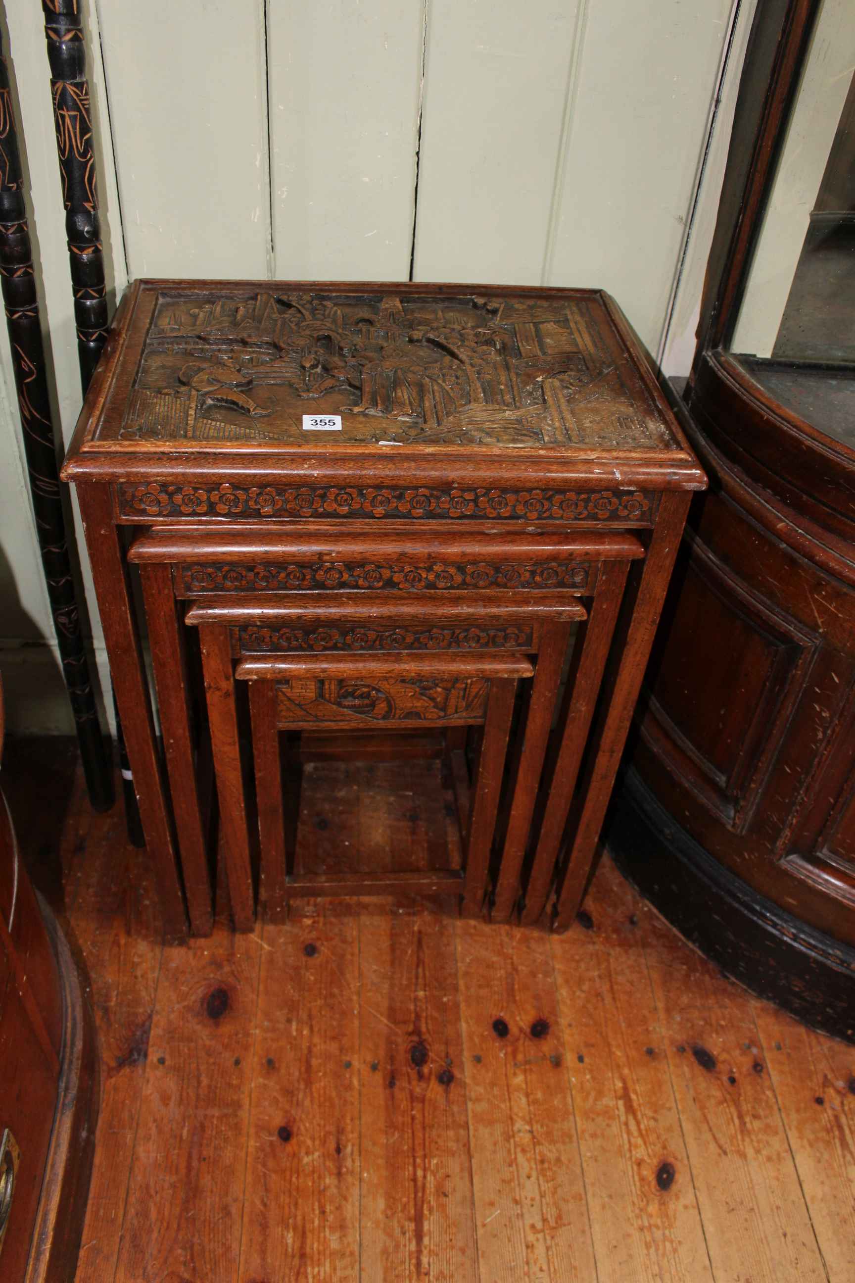 Nest of four carved Oriental tables (largest 67cm by 51cm by 35cm).