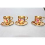 Three Royal Worcester fruit painted cups and saucers, having gilt gadroon borders and interiors,