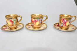 Three Royal Worcester fruit painted cups and saucers, having gilt gadroon borders and interiors,