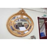 Large ornate gilt framed bevelled wall mirror with floral and swag crest,
