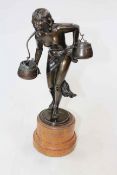 Bronze semi-naked water carrier, 38.5cm.