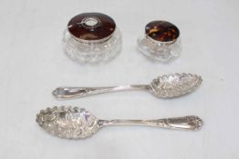 Two silver and tortoiseshell topped toilet jars, and pair of EP berry spoons (3).