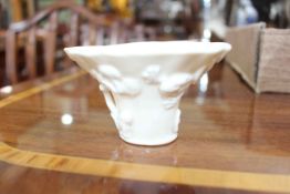 Chinese cream porcelain libation cup, with relief decoration, 10cm across.