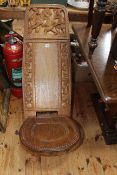 Carved African hardwood birthing chair.